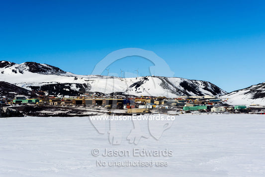 The green buildings of Scott Base on the shore of the sea ice in Antarctica. McMurdo Station, Ross Island, Antarctica.