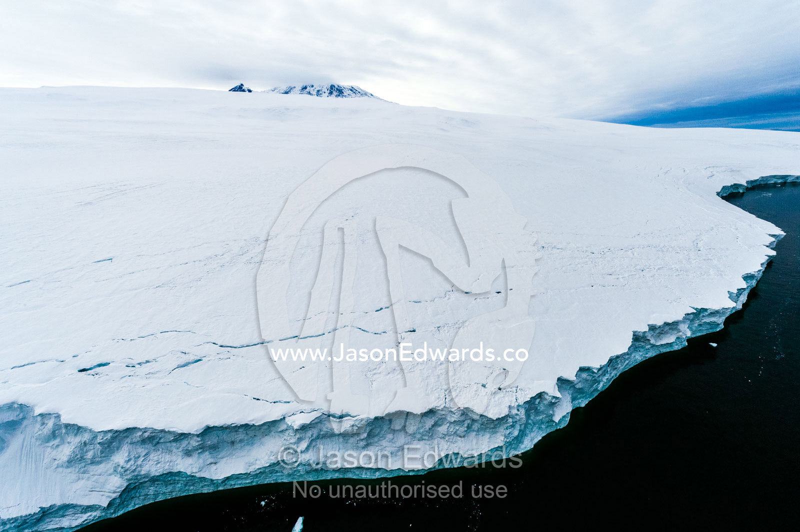 Towering ocean ice cliffs and crevasse fields of a glacier flowing off the slopes of Mount Erebus an active volcano. Wohlschlag Bay, Endeavour Piedmont, Mount Erebus, Ross Island, Antarctica.