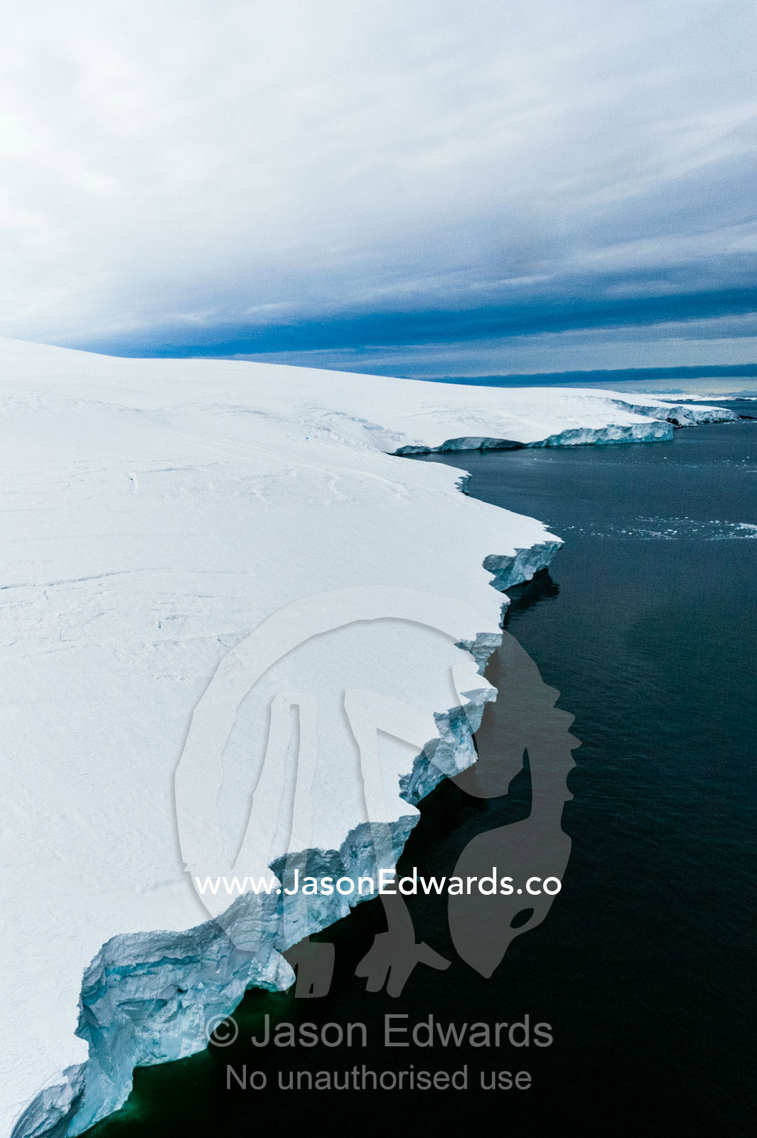 Towering ocean ice cliffs and crevasse fields of a glacier flowing off the slopes of Mount Erebus an active volcano. Wohlschlag Bay, Endeavour Piedmont, Mount Erebus, Ross Island, Antarctica.