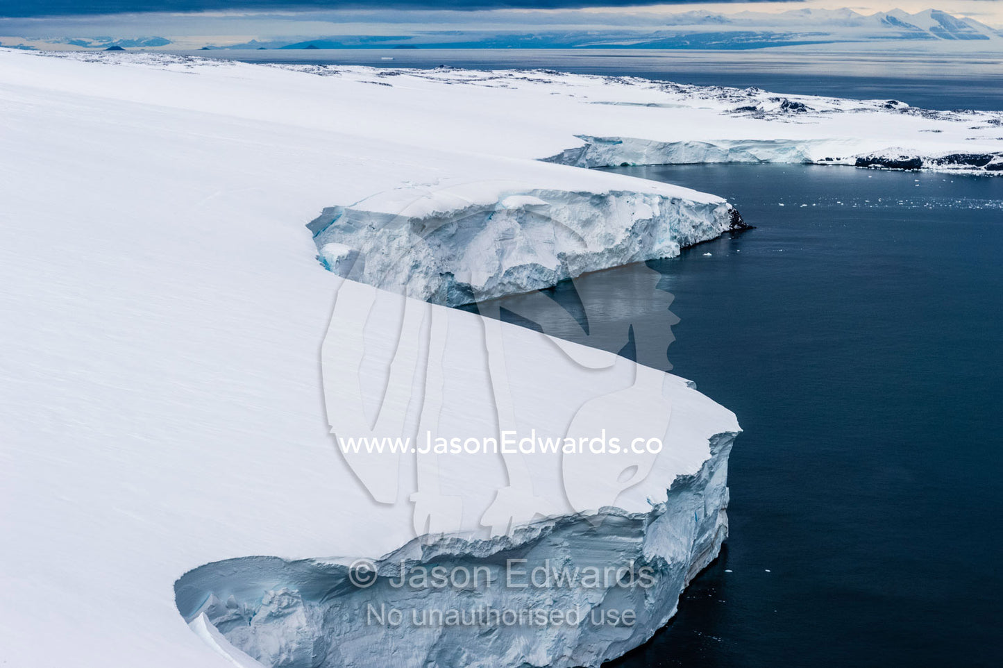 Towering ocean ice cliffs and crevasse fields of a glacier flowing off the slopes of Mount Erebus an active volcano. Wohlschlag Bay, Endeavour Piedmont, Mount Erebus, Ross Island, Antarctica.