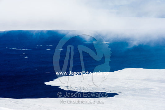 Open ocean lines the ice edge as sea ice melts in the Antarctic summer. McMurdo Sound, Ross Island, Antarctica.