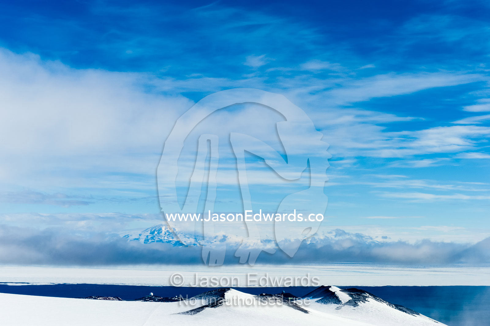 A snow and ice covered mountain plateau overlooking the Ross Sea. Royal Society Range, McMurdo Sound, Ross Island, Antarctica.