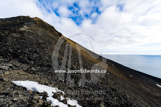 Melting snow on the slopes of a volcanic mountain during the Antarctic summer. Observation Hill, McMurdo Sound, Ross Island, Antarctica.