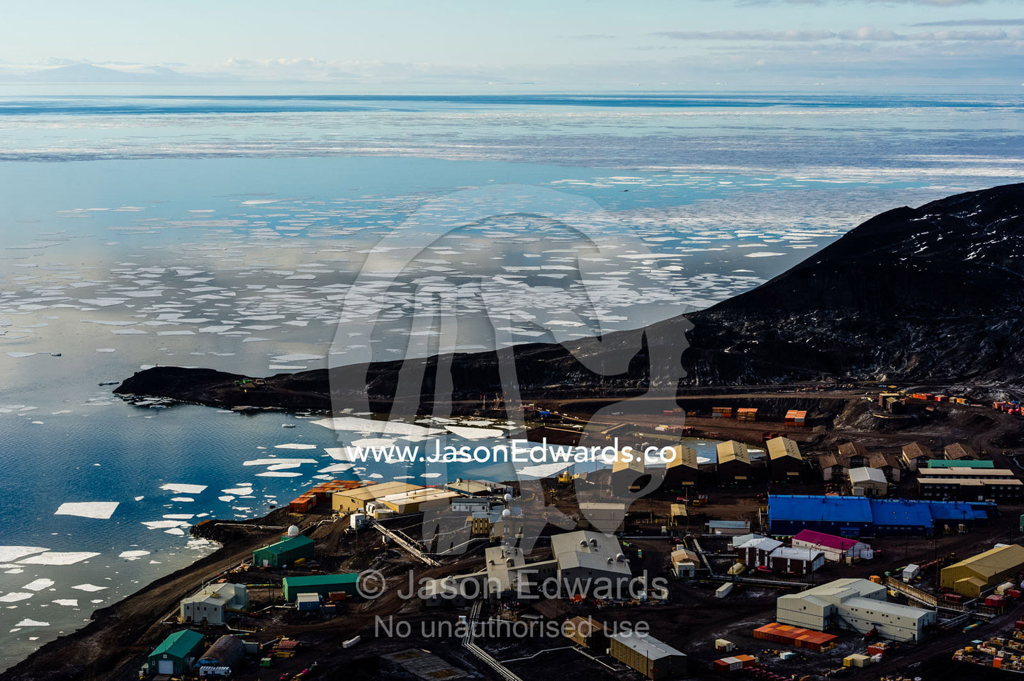 The enormous oil tanks and sprawling facilities of McMurdo Station the largest base in Antarctica. McMurdo Sound, McMurdo Station, Ross Island, Antarctica.