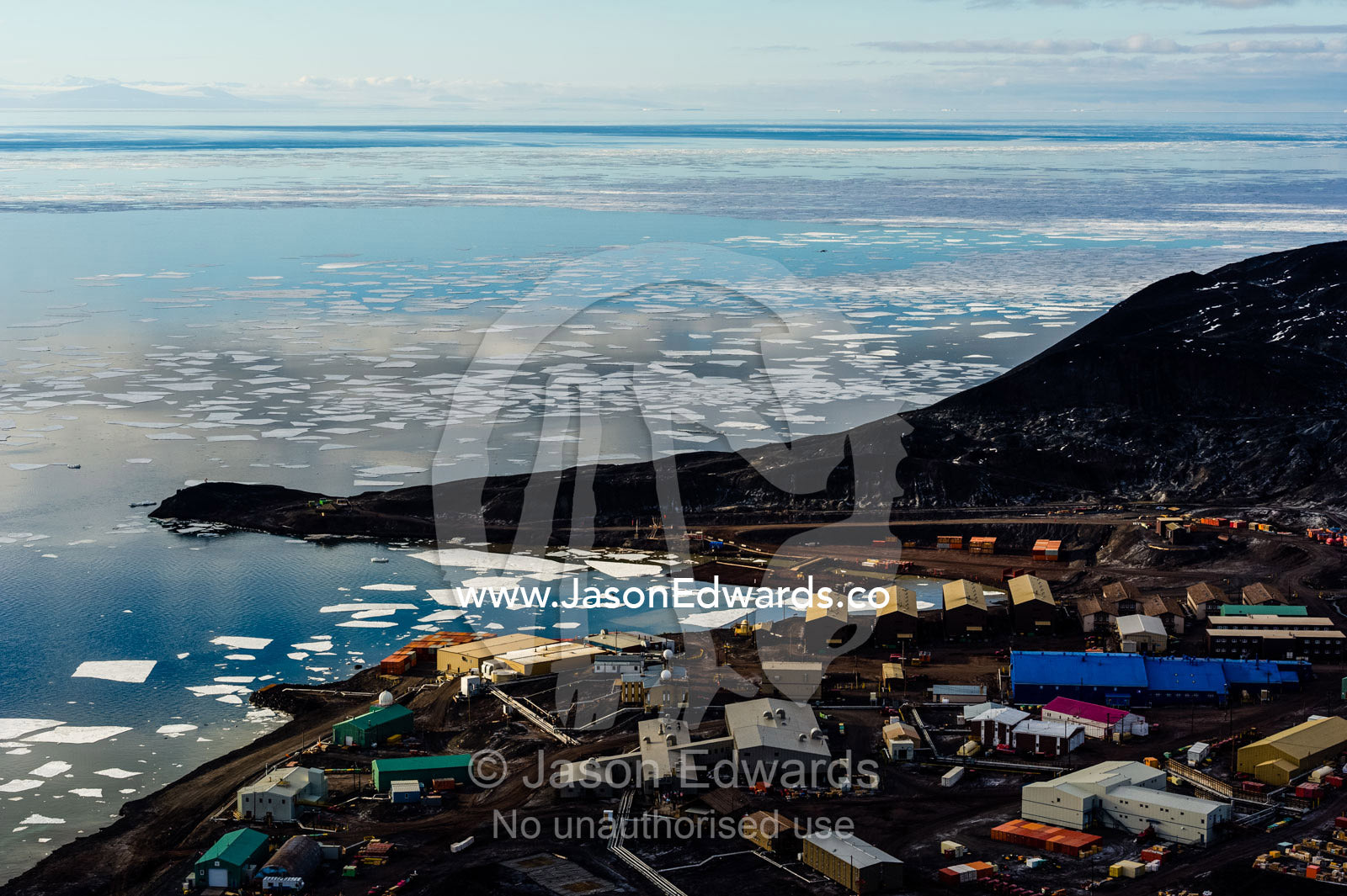 The enormous oil tanks and sprawling facilities of McMurdo Station the largest base in Antarctica. McMurdo Sound, McMurdo Station, Ross Island, Antarctica.