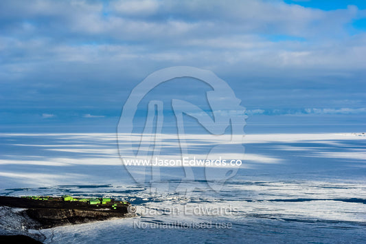 Tiny Scott Base perched on an outcrop of rock overlooking the sea ice in Antarctica. Scott Base, Pram Point, Hut Point Peninsula, Ross Island, Antarctica.