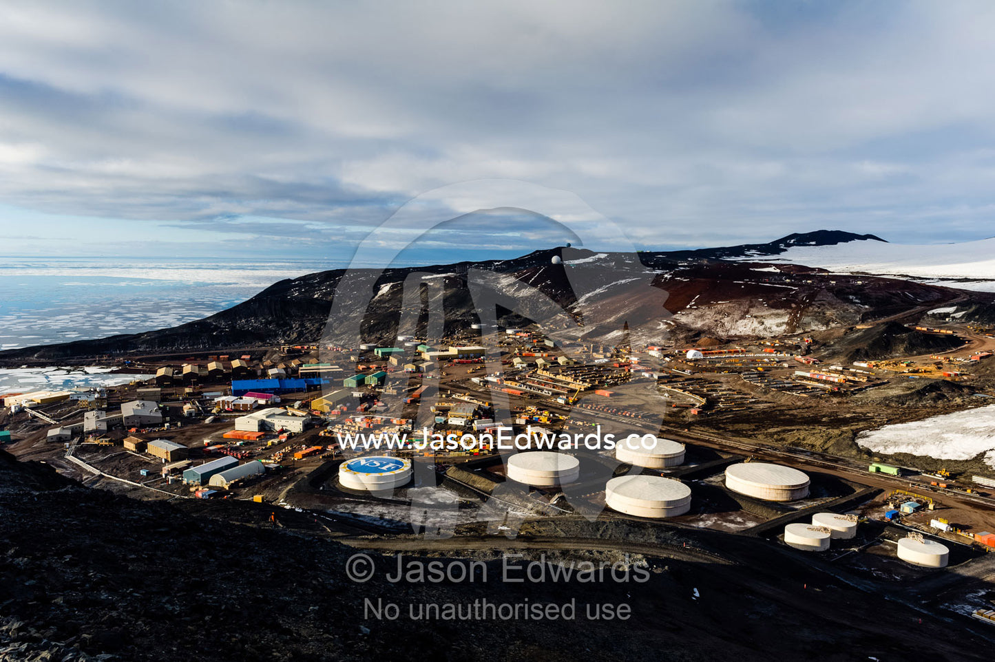 The enormous oil tanks and sprawling facilities of McMurdo Station the largest base in Antarctica. McMurdo Station, Ross Island, Antarctica.