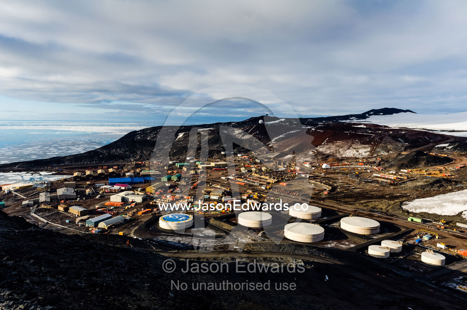 The enormous oil tanks and sprawling facilities of McMurdo Station the largest base in Antarctica. McMurdo Station, Ross Island, Antarctica.