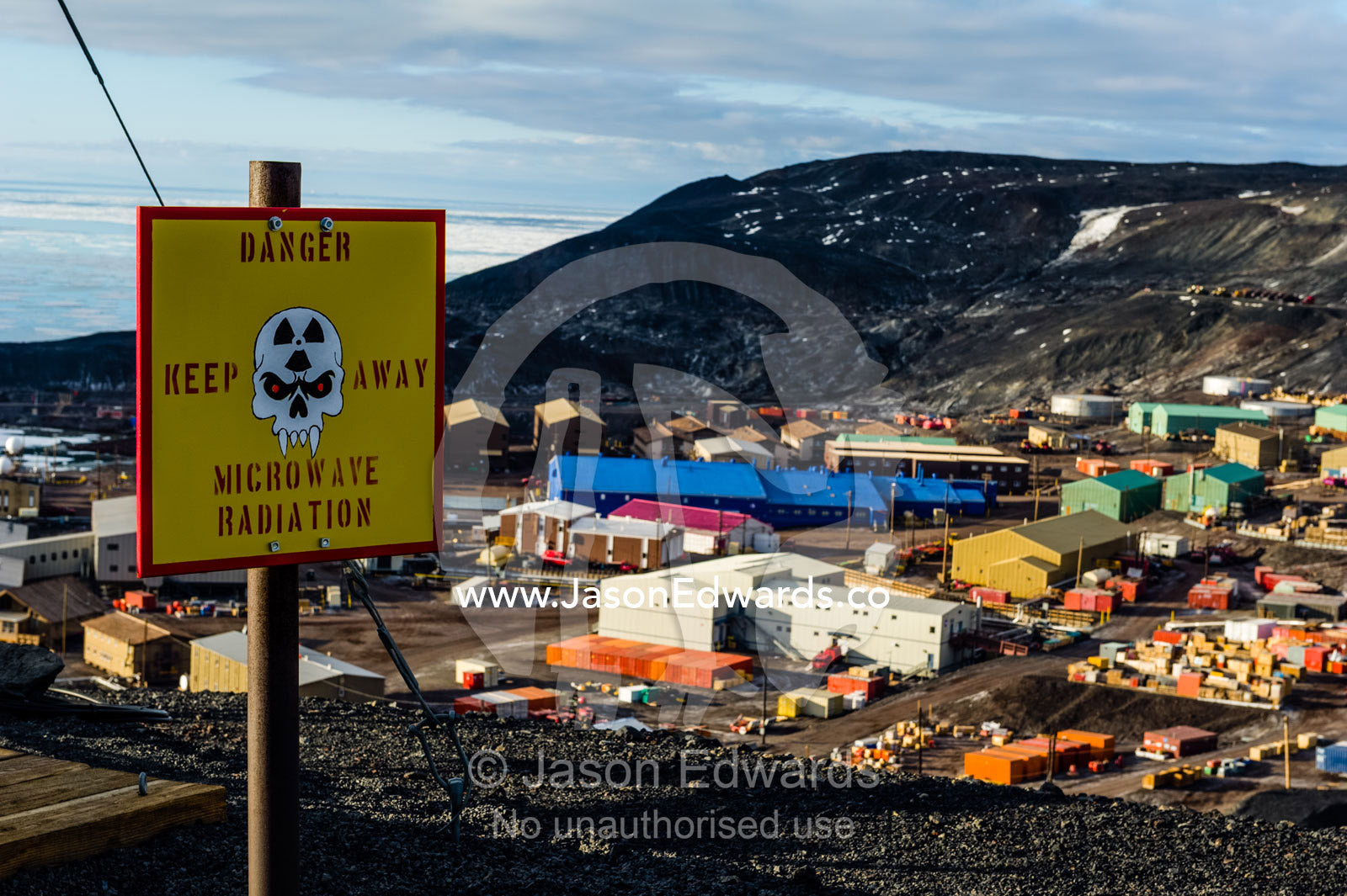 Skull and fang warning signs at a dangerous microwave radiation research site. McMurdo Station, Ross Island, Antarctica.