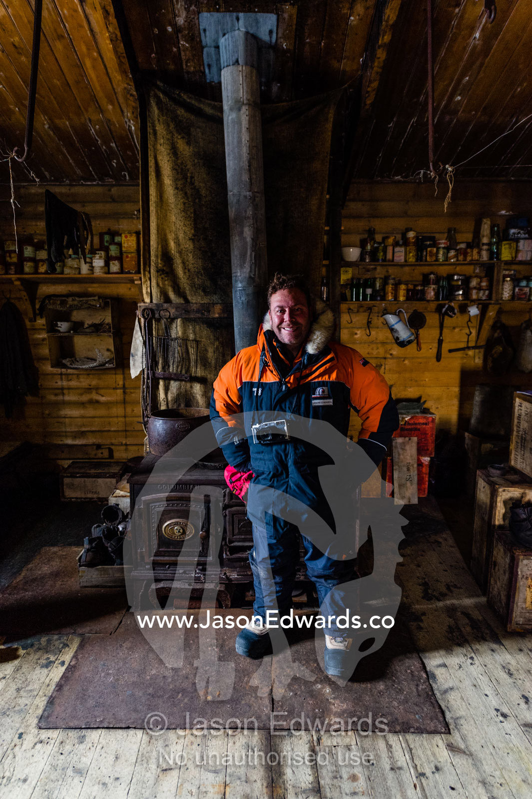 National Geographic photographer Jason Edwards in Ernest Shackleton's Hut in Antarctica. Shackleton's Hut, Cape Royds, Ross Island, Antarctica.