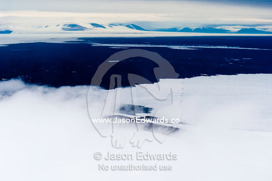 Mist and cloud shroud the sea ice near open ocean in the Antarctic summer. McMurdo Sound, Ross Island, Antarctica.