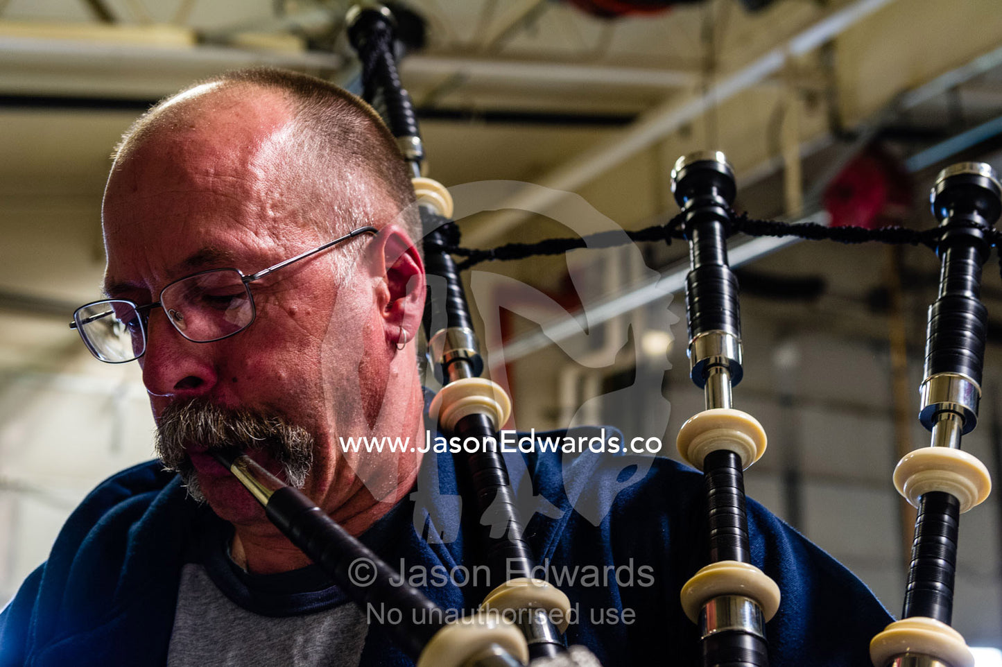 A tradesman on an Antarctic base practices the bagpipes in his workshop. Scott Base, Pram Point, Hut Point Peninsula, Ross Island, Antarctica.