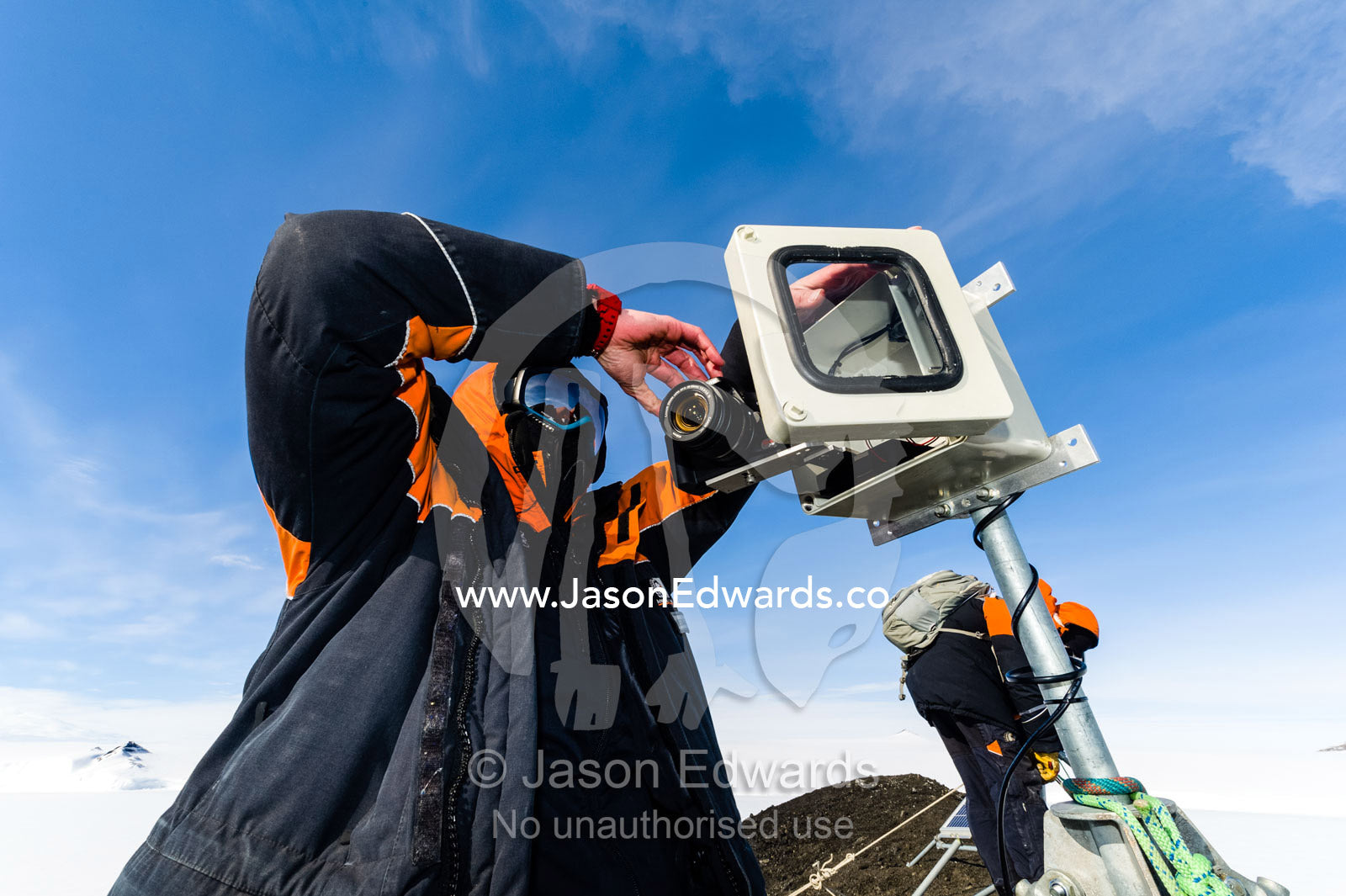 A scientist monitors a remote control camera capturing time lapse photographs of Weddell Seals and sea ice movements. Turtle Rock, Erebus Bay, McMurdo Sound, Ross Island, Antarctica.