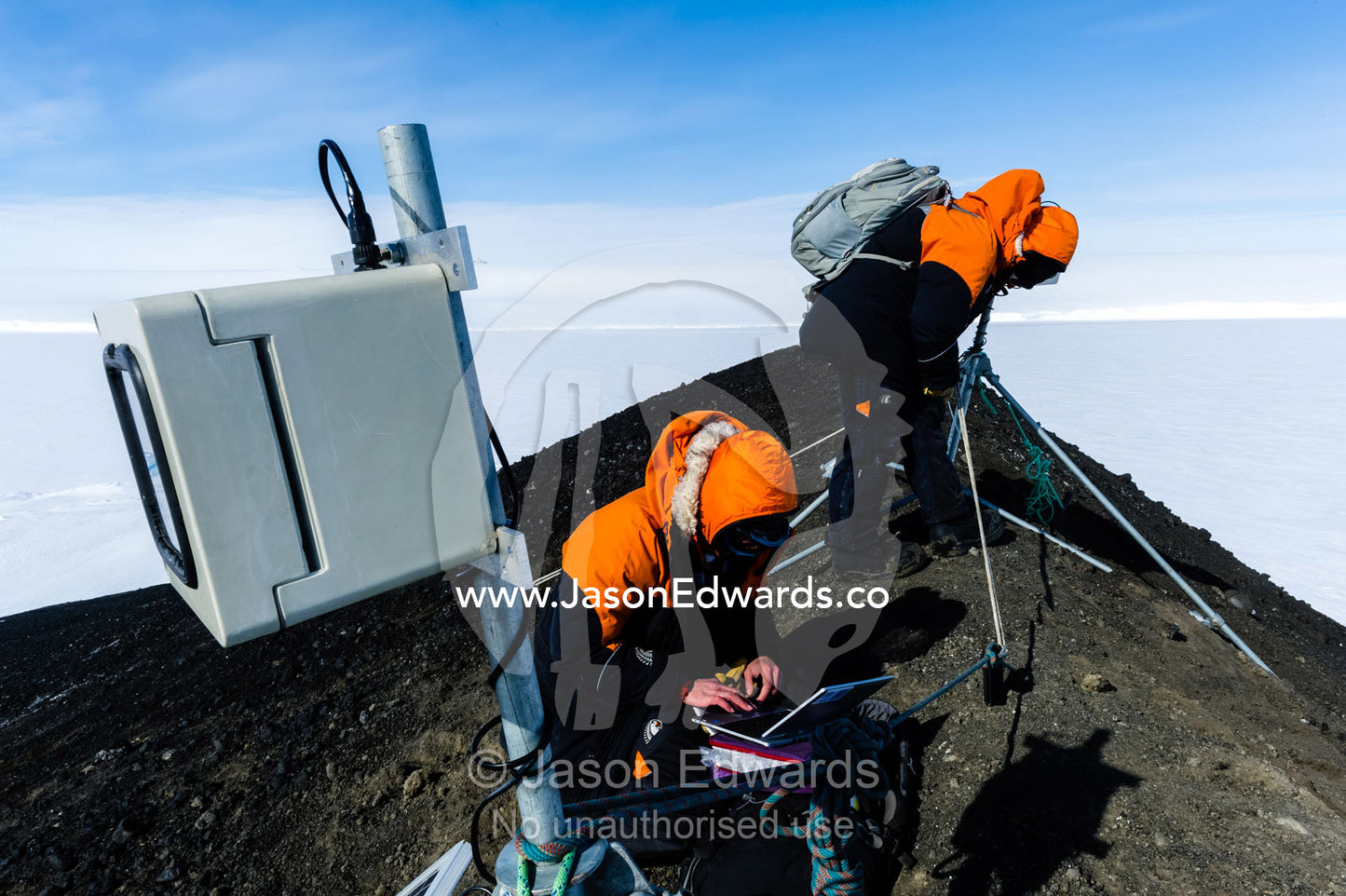 A scientist monitors a remote control camera capturing time lapse photographs of Weddell Seals and sea ice movements. Turtle Rock, Erebus Bay, McMurdo Sound, Ross Island, Antarctica.
