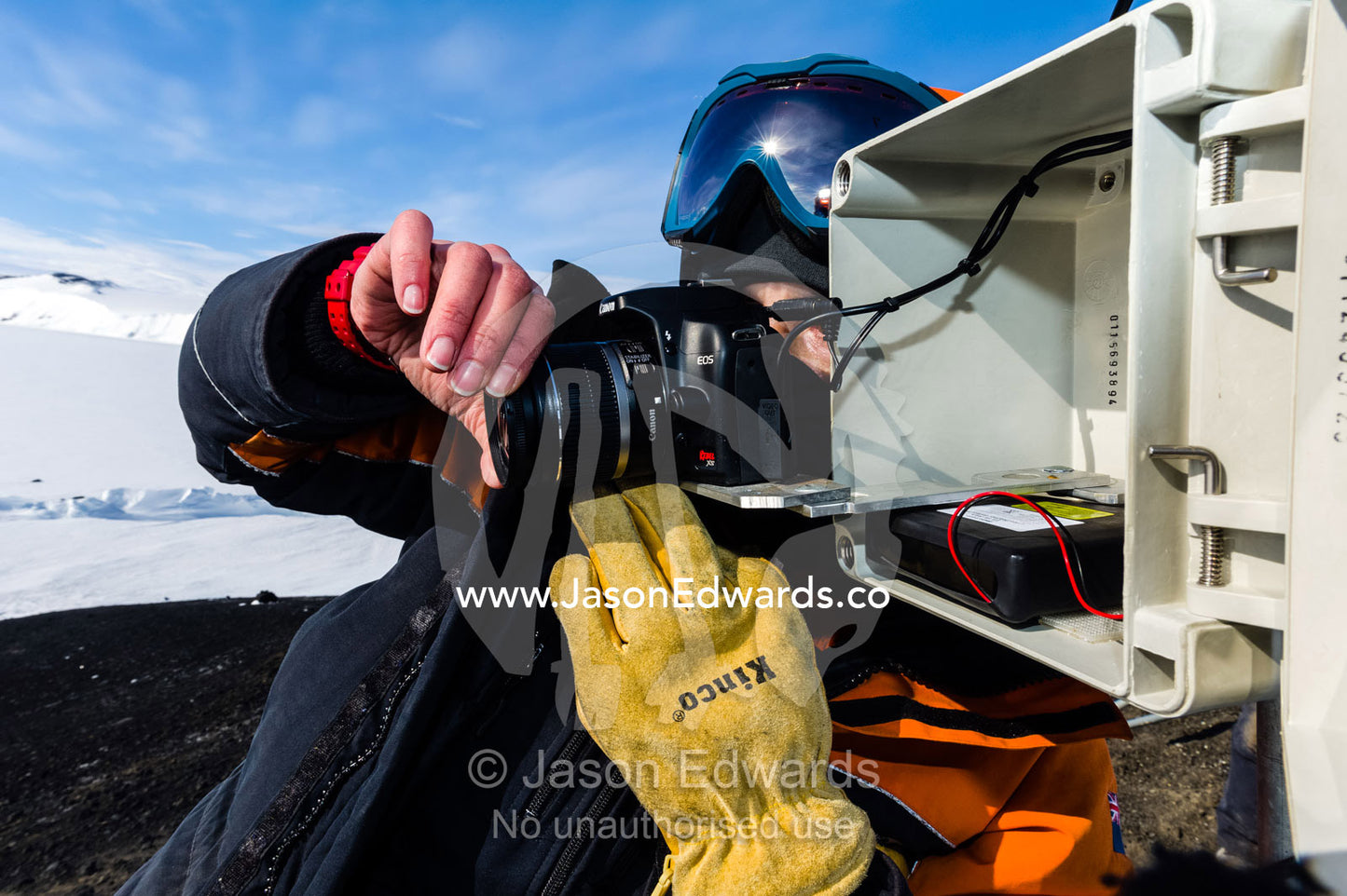 A scientist monitors a remote control camera capturing time lapse photographs of Weddell Seals and sea ice movements. Turtle Rock, Erebus Bay, McMurdo Sound, Ross Island, Antarctica.