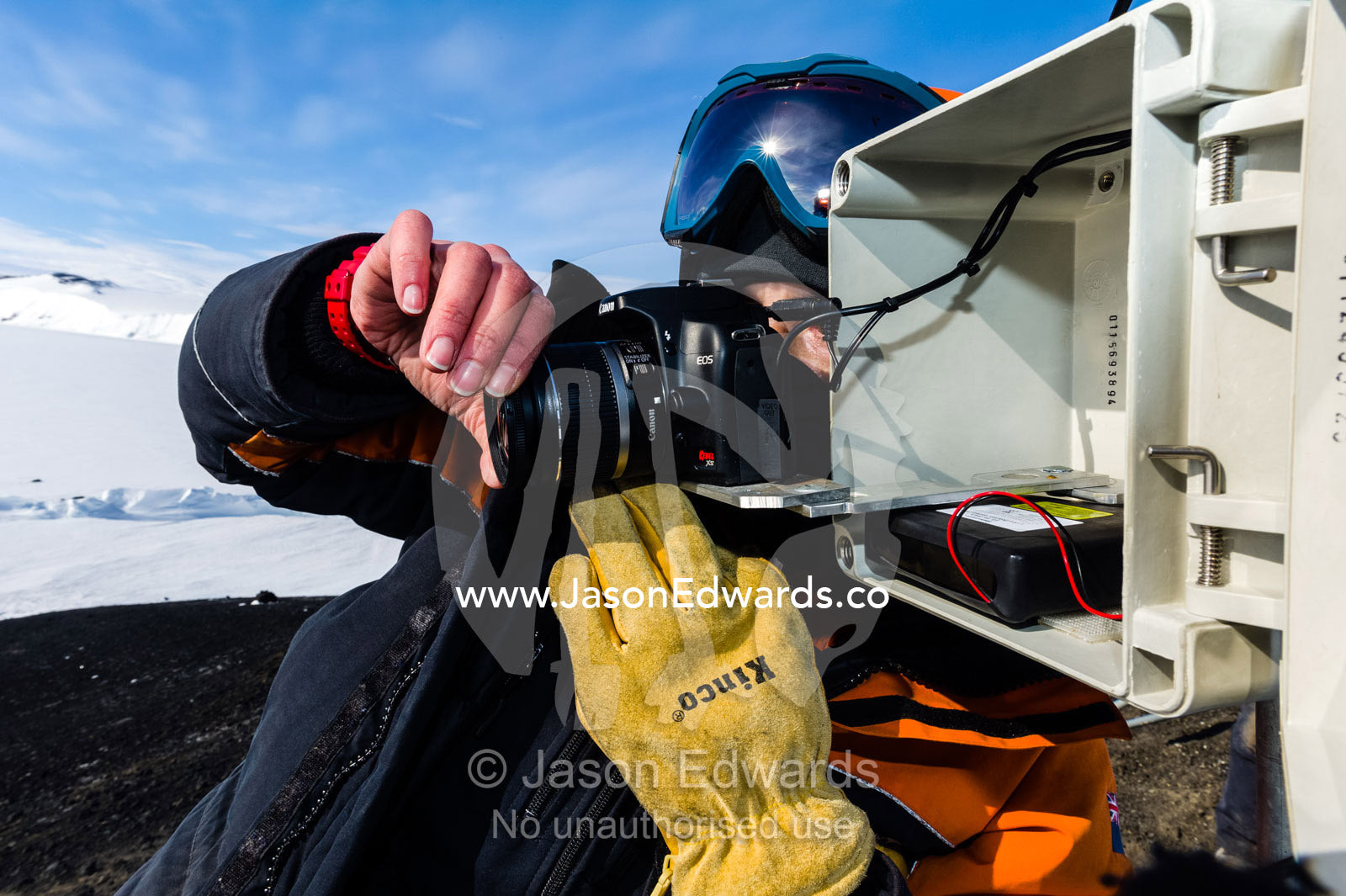 A scientist monitors a remote control camera capturing time lapse photographs of Weddell Seals and sea ice movements. Turtle Rock, Erebus Bay, McMurdo Sound, Ross Island, Antarctica.