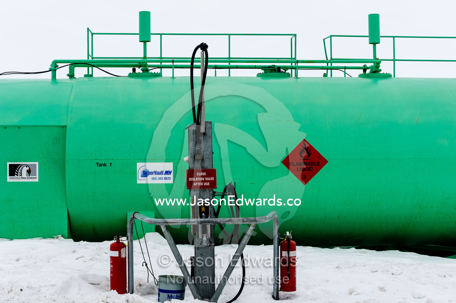 A petrol tank and bowser surrounded by snow in Antarctica. Scott Base, Pram Point, Hut Point Peninsula, Ross Island, Antarctica.