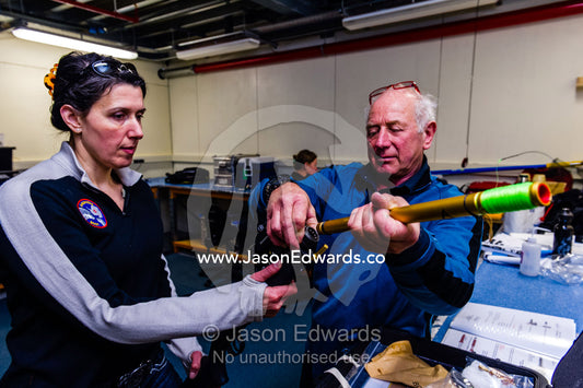 Scientists prepare a wildlife dart gun to be used to collect Killer Whale tissue samples. Scott Base, Pram Point, Hut Point Peninsula, Ross Island, Antarctica.
