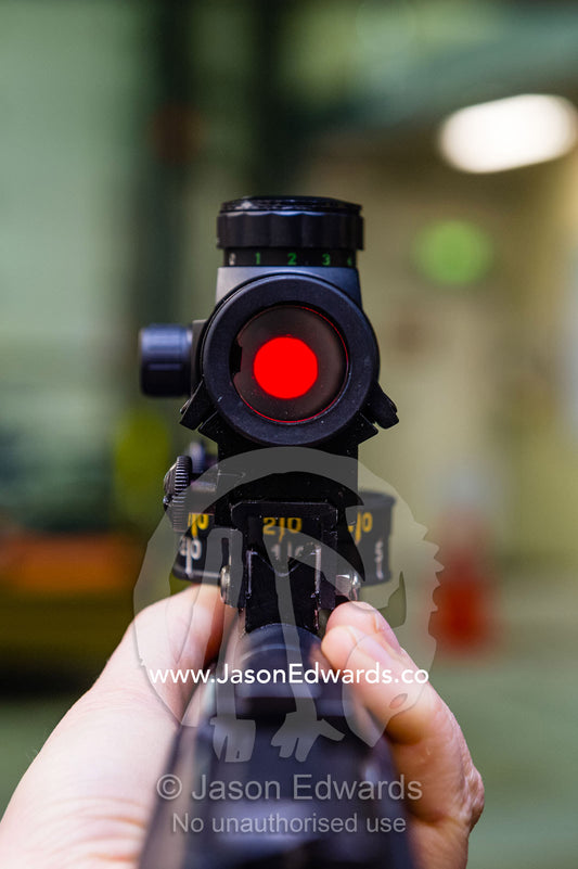 A bright red laser dot in the targeting scope of a wildlife dart gun used to collect Killer Whale tissue samples. Scott Base, Pram Point, Hut Point Peninsula, Ross Island, Antarctica.