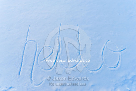 The word hello written in fresh snow on the sea ice. Pram Point, McMurdo Sound, Ross Island, Antarctica.