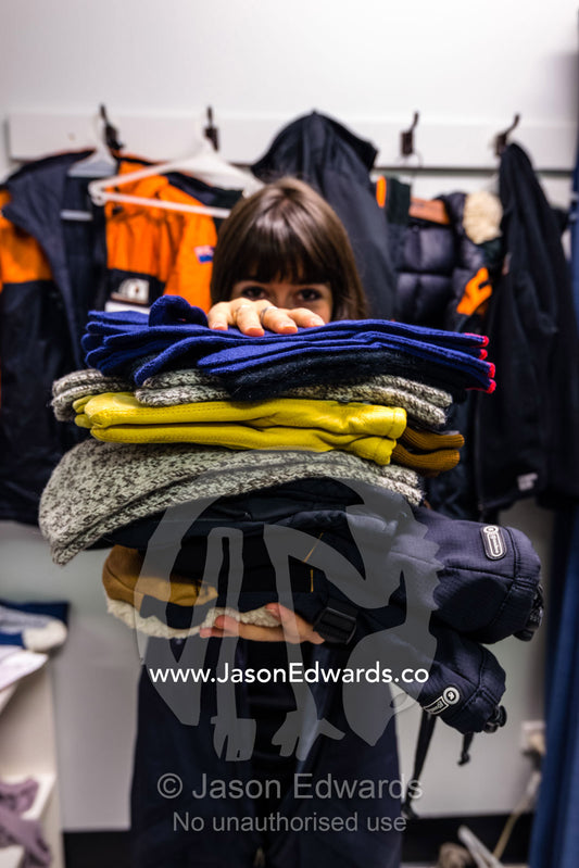 A volunteer displays survival clothing to be worn in Antarctica. Antarctica New Zealand, Christchurch, New Zealand.
