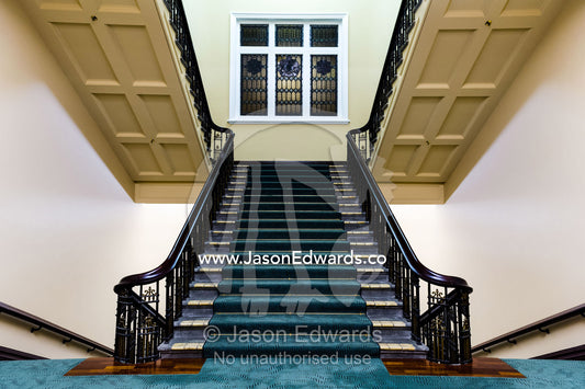 An elegant heritage stairwell and balustrade in a renovated hotel. Heritage Hotel Christchurch, Christchurch, New Zealand.