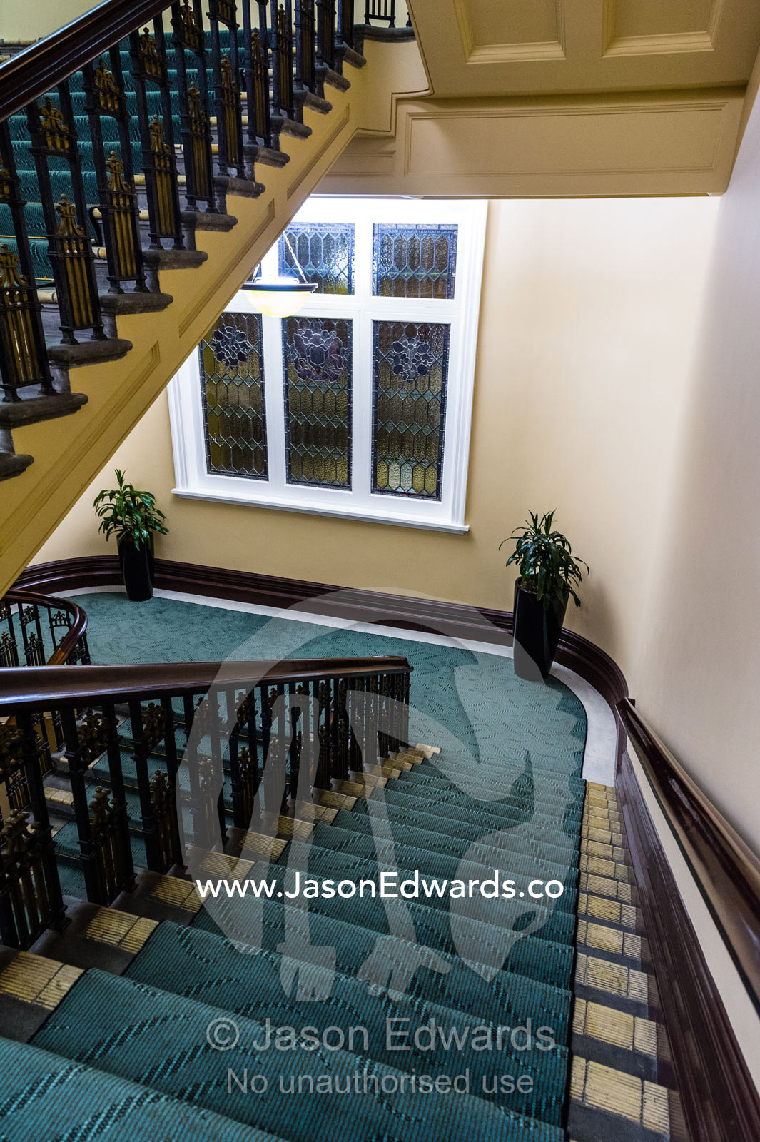 An elegant heritage stairwell and balustrade in a renovated hotel. Heritage Hotel Christchurch, Christchurch, New Zealand.