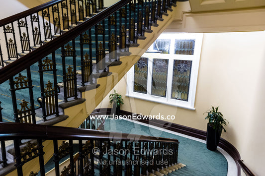 An elegant heritage stairwell and balustrade in a renovated hotel. Heritage Hotel Christchurch, Christchurch, New Zealand.