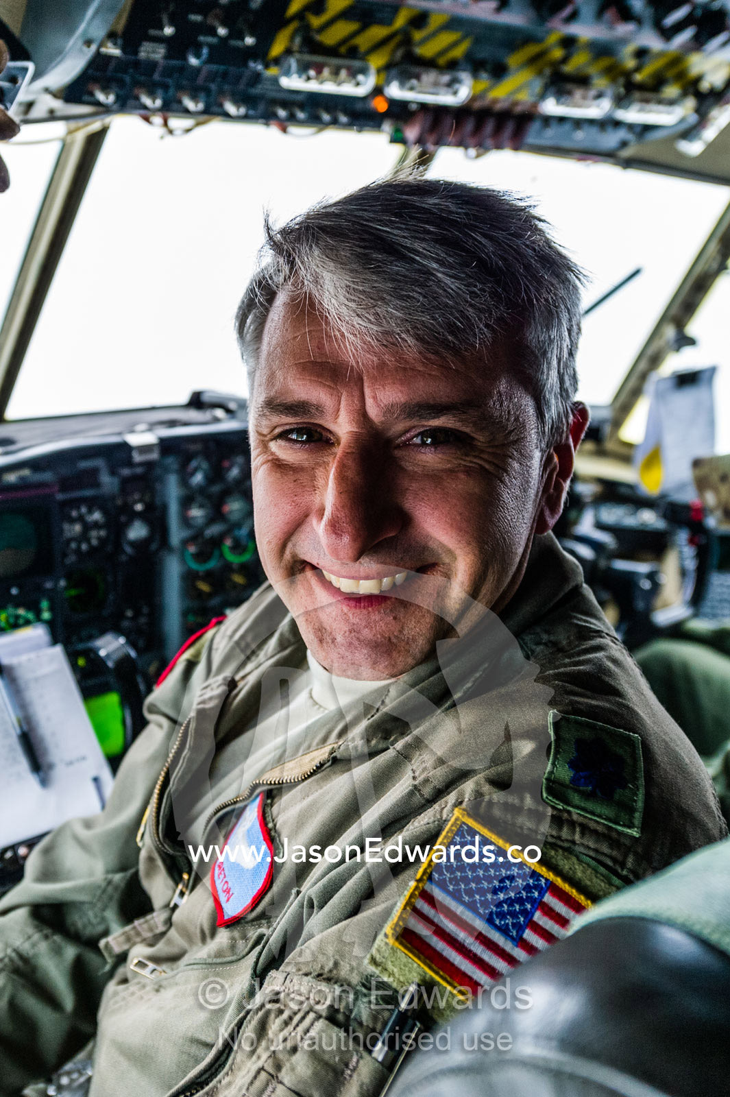 The pilot of a US air force Hercules flight crew in the cockpit flying to Antarctica. Southern Ocean, between New Zealand and Antarctica.