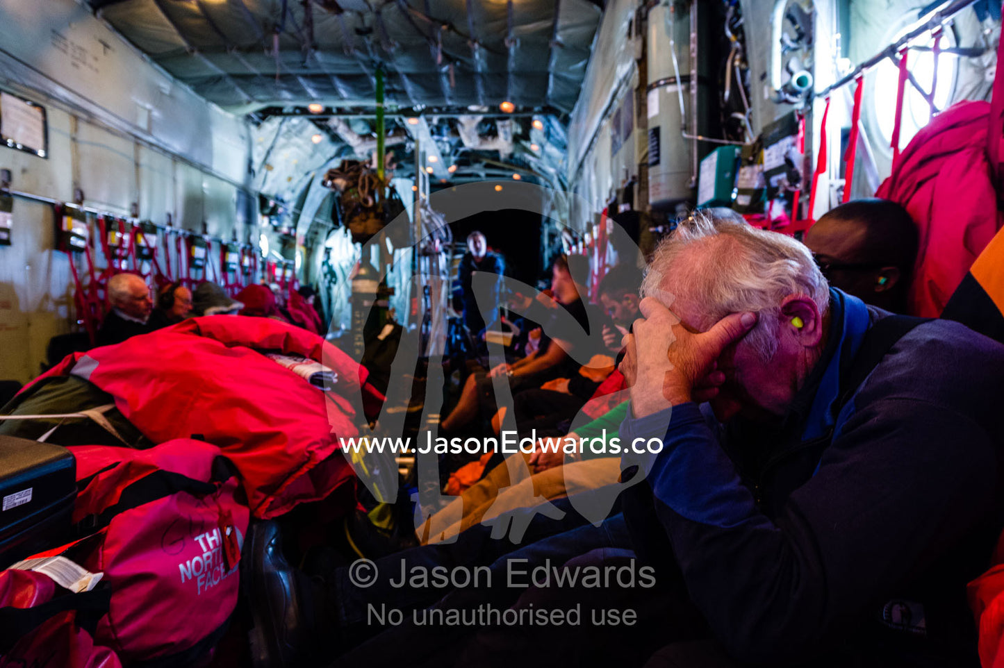 Scientists and staff passengers sleeping inside a US Air force Hercules fuselage flying to Antarctica. Southern Ocean, between New Zealand and Antarctica.