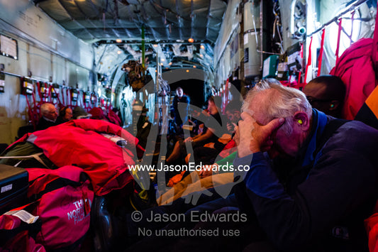 Scientists and staff passengers sleeping inside a US Air force Hercules fuselage flying to Antarctica. Southern Ocean, between New Zealand and Antarctica.
