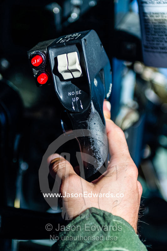 A US Air force co-pilot flying a Hercules to Antarctica using the control joystick. Ross Sea, Antarctica.