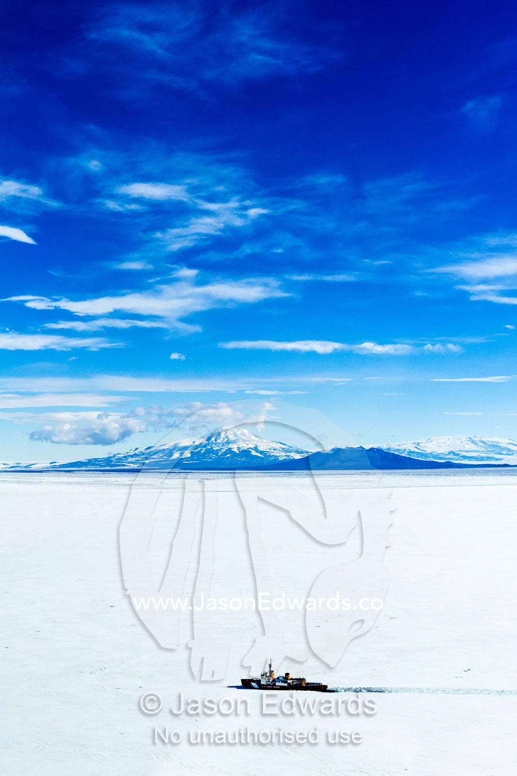 A Coast Guard icebreaker ploughs it's way through sea ice in Antarctica. McMurdo Sound, Ross Sea, Antarctica.