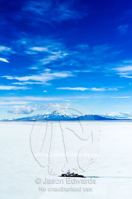 A Coast Guard icebreaker ploughs it's way through sea ice in Antarctica. McMurdo Sound, Ross Sea, Antarctica.