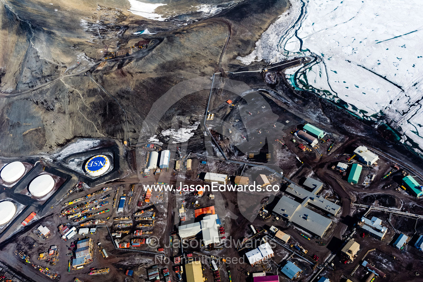 The view of McMurdo Station beneath Observation Hill through the cockpit of a US Air force Hercules cockpit. McMurdo Station, Ross Island, Antarctica.