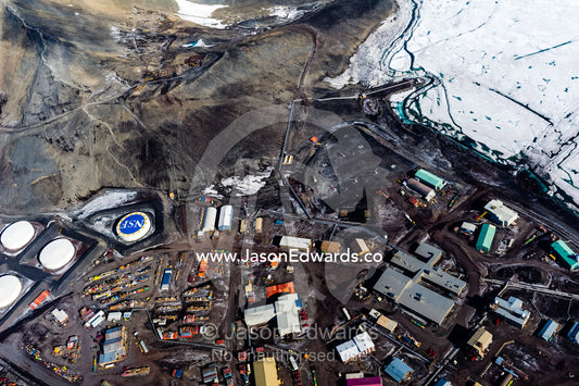 The view of McMurdo Station beneath Observation Hill through the cockpit of a US Air force Hercules cockpit. McMurdo Station, Ross Island, Antarctica.