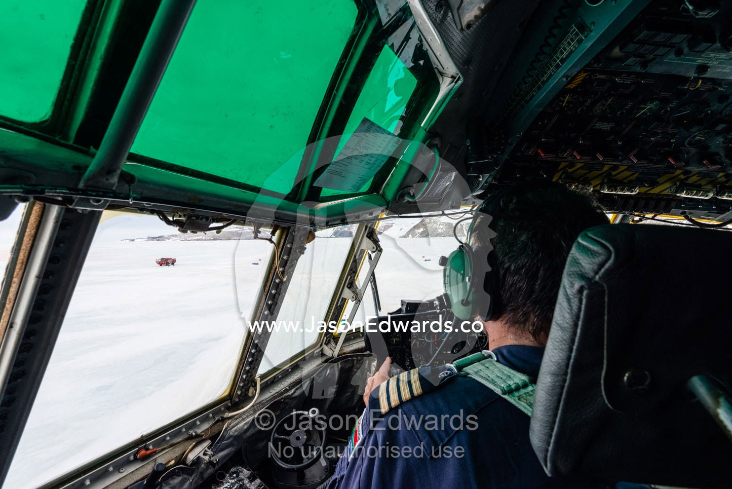 The South African pilot of a US Air force Hercules waiting on an ice runway to takeoff. Zucchelli Station, Terra Nova Bay, Victoria Land, Antarctica.