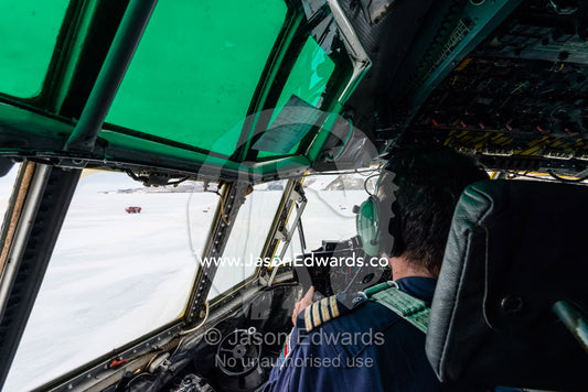 The South African pilot of a US Air force Hercules waiting on an ice runway to takeoff. Zucchelli Station, Terra Nova Bay, Victoria Land, Antarctica.