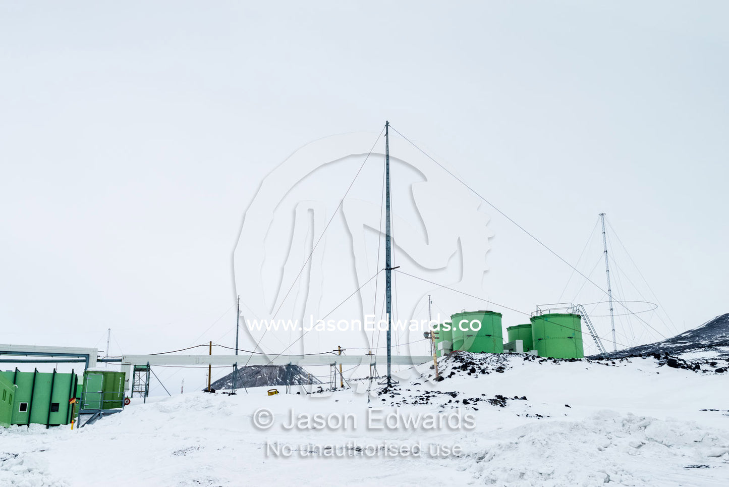 The green buildings of Scott Base in Antarctica stand out against the snow and ice. Scott Base, Pram Point, Hut Point Peninsula, Ross Island, Antarctica.