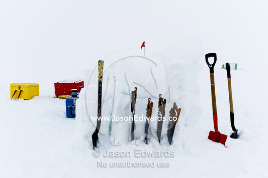 Snow shovels and ice saws used to make a kitchen shelter during a survival course on the sea ice. Windless Bight, Ross Ice Shelf, Ross Island, Antarctica.
