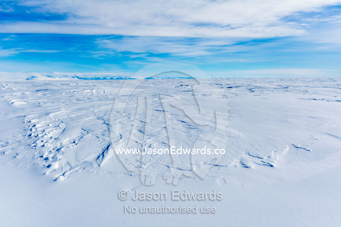Snow drifts blown across the surface of the sea ice. Erebus Bay, McMurdo Sound, Cape Evans, Ross Island Antarctica.