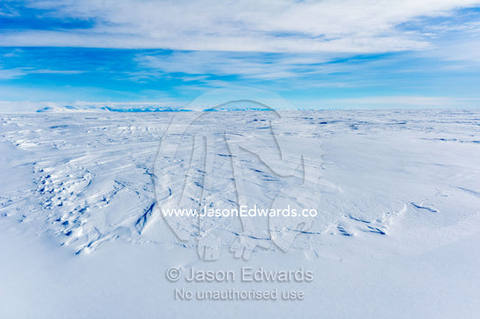 Snow drifts blown across the surface of the sea ice. Erebus Bay, McMurdo Sound, Cape Evans, Ross Island Antarctica.