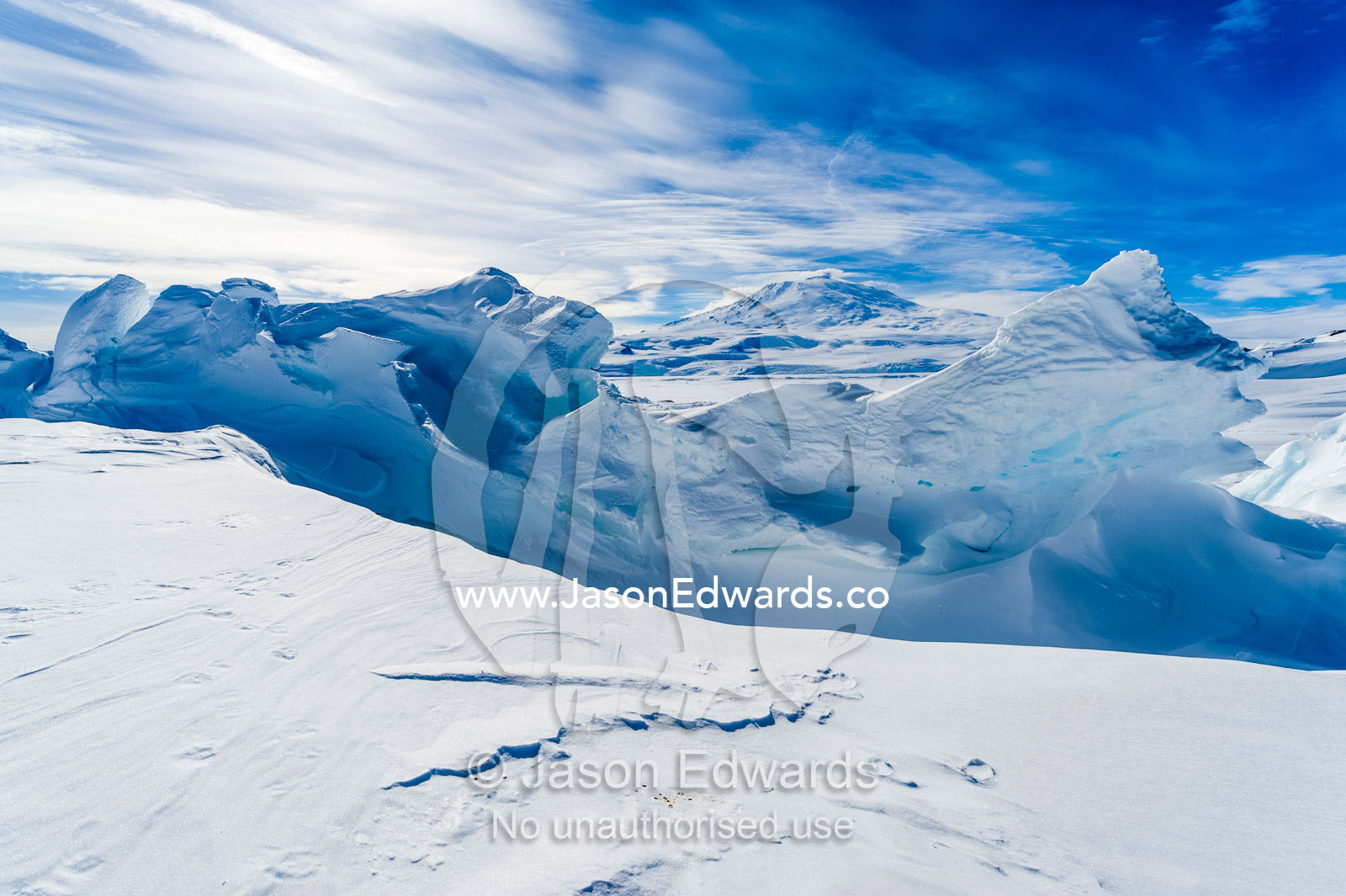Snow drifts piled against pressure ridges in the sea ice. Mount Erebus, Erebus Bay, McMurdo Sound, Ross Island, Antarctica.