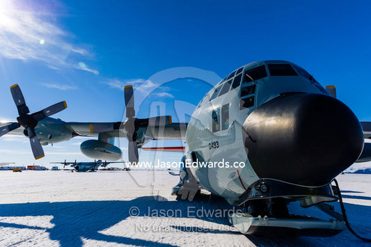 US Air force Hercules resting on skis on a sea ice tarmac. Royal Society Range, Pegasus Field, McMurdo Ice Shelf, Ross Island, McMurdo Sound, Antarctica.