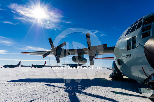 US Air force Hercules resting on skis on a sea ice tarmac. Royal Society Range, Pegasus Field, McMurdo Ice Shelf, Ross Island, McMurdo Sound, Antarctica.