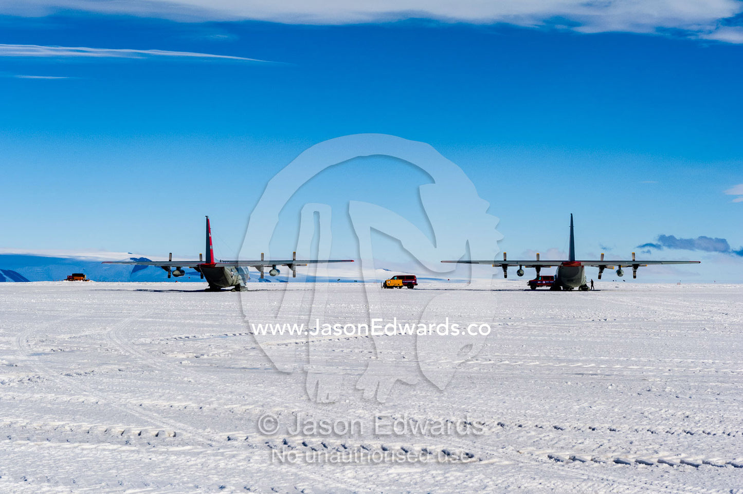 US Air force Hercules resting on skis on a sea ice tarmac. Royal Society Range, Pegasus Field, McMurdo Ice Shelf, Ross Island, McMurdo Sound, Antarctica.