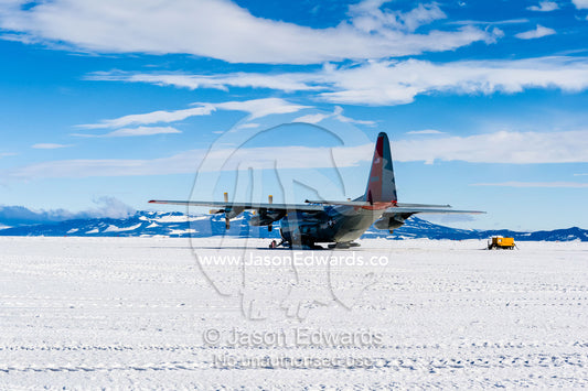 US Air force Hercules resting on skis on a sea ice tarmac. Royal Society Range, Pegasus Field, McMurdo Ice Shelf, Ross Island, McMurdo Sound, Antarctica.