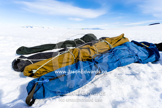 Packed survival training course tents resting on the sea ice. Windless Bight, Ross Ice Shelf, Ross Island, Antarctica.