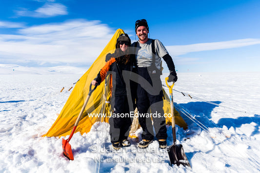 Antarctic base staff pitching a survival tent on the sea ice. Windless Bight, Ross Ice Shelf, Ross Island, Antarctica.