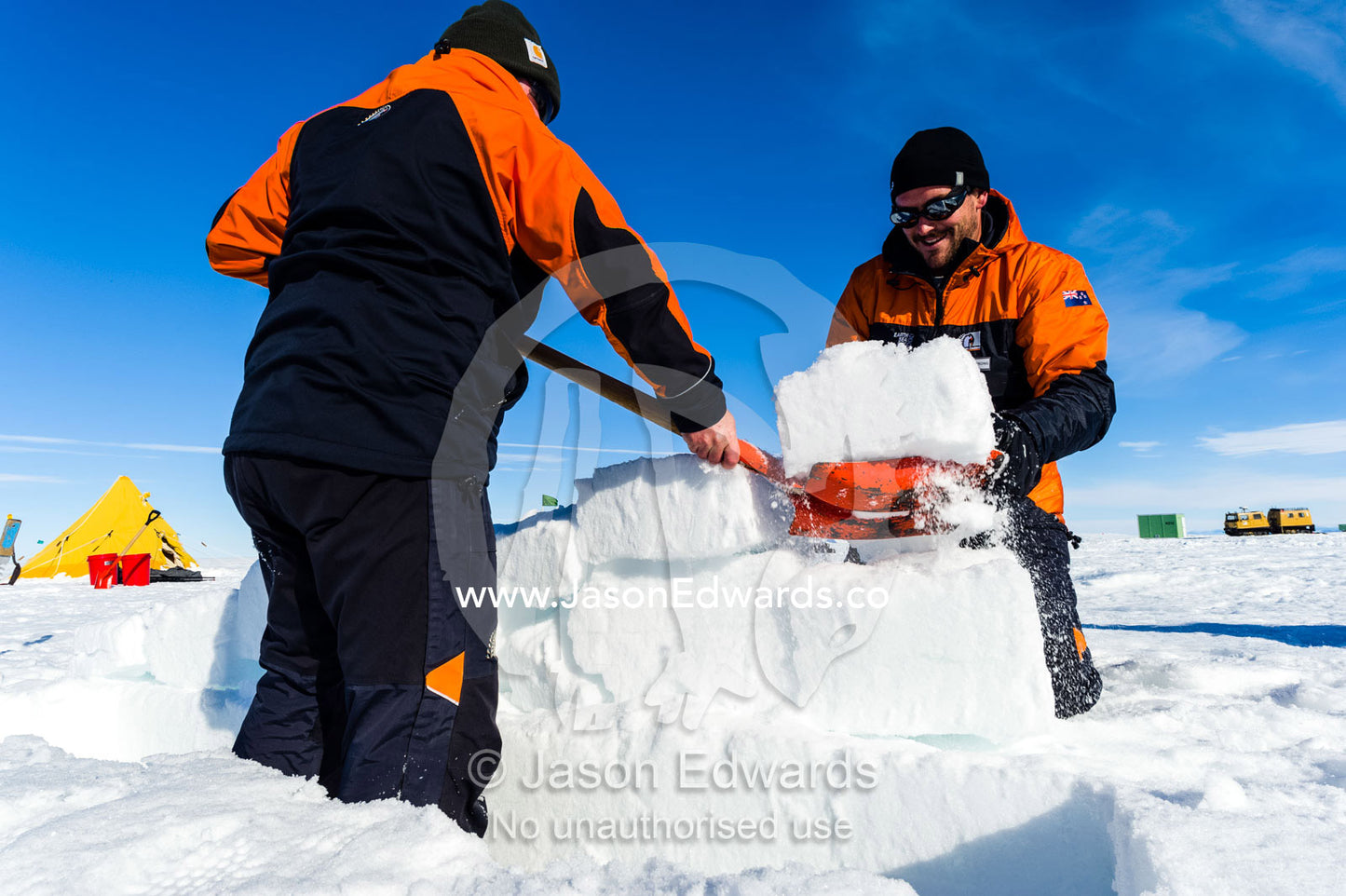 Antarctic base staff cutting ice bricks to make a kitchen wall on the sea ice during a survival course. Windless Bight, Ross Ice Shelf, Ross Island, Antarctica.